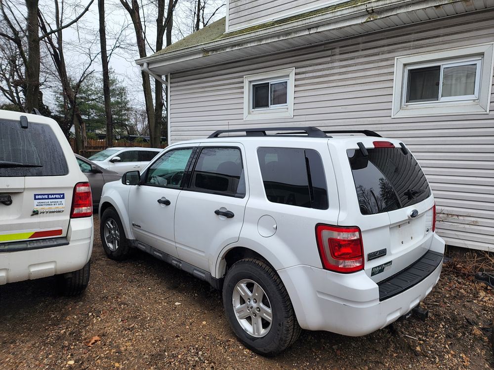 White Ford Escape outside the shop in Huntington Station