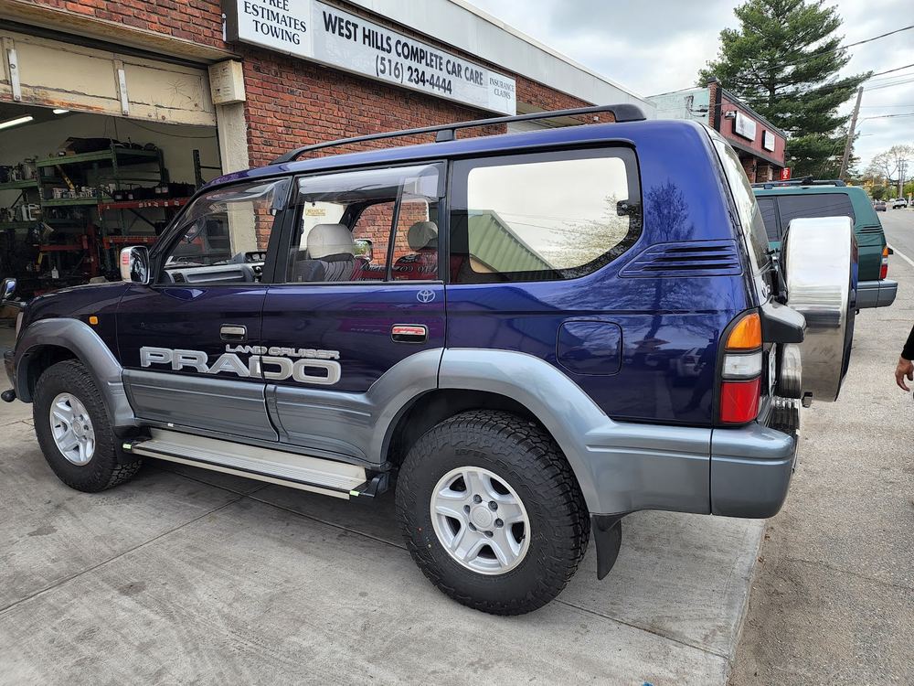 Blue Toyota Land Cruiser Prado outside the shop
