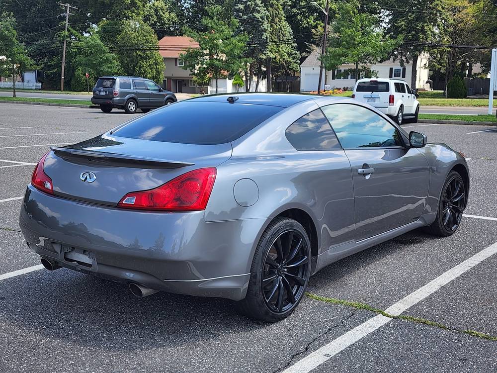 Silver Infiniti coupe parked outside the shop