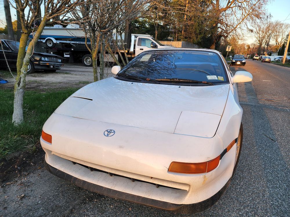 White Toyota MR2 parked outside the shop