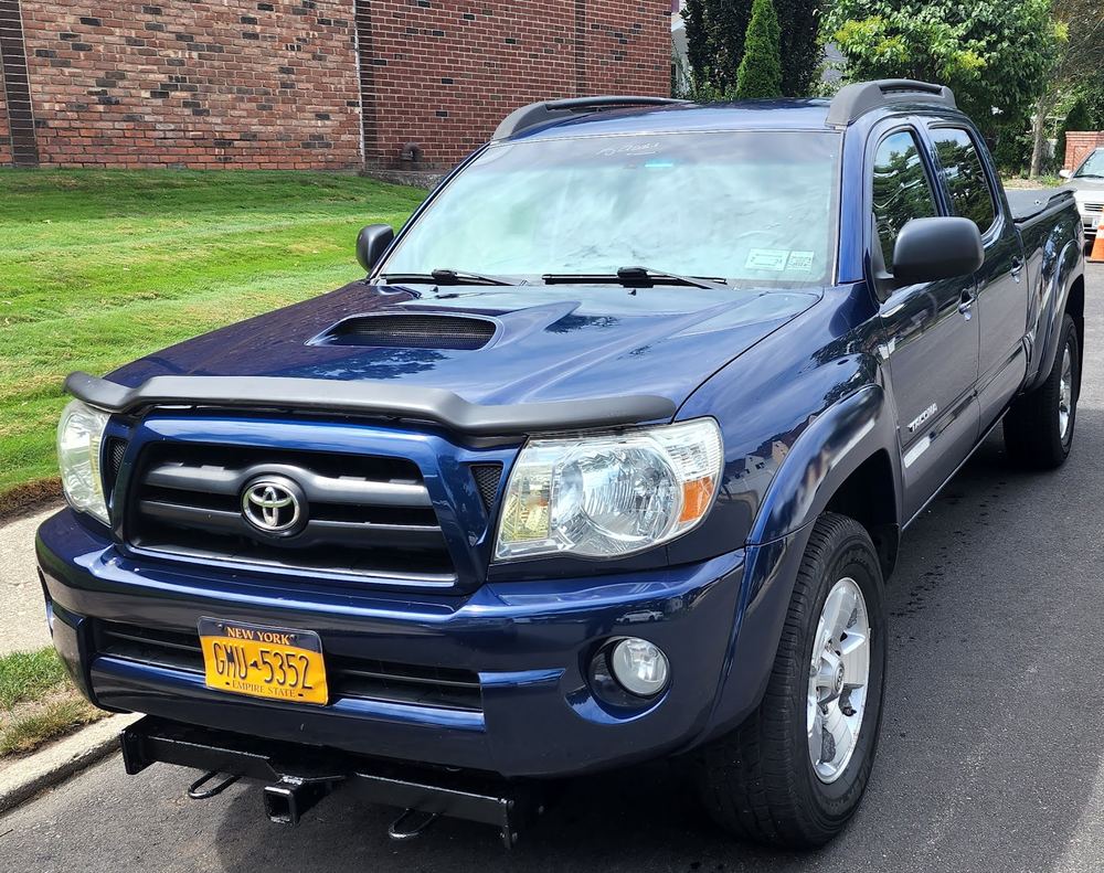 Blue Toyota Tacoma pickup after repair